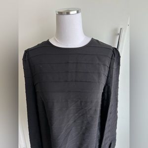 Tory Burch black long sleeved blouse. Line detail w/ 3 button back closure.